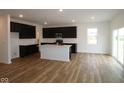 Spacious kitchen with dark cabinets, a center island, stainless steel appliances, and hardwood floors at 2268 Marjorie Way, Shelbyville, IN 46176