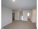 Neutral-toned loft area with carpet, natural light, and multiple doorways at 2268 Marjorie Way, Shelbyville, IN 46176