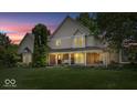Beautiful home with a welcoming front porch under a colorful twilight sky at 244 W Admiral S Way, Carmel, IN 46032
