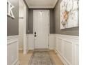 Inviting entryway with gray walls, white wainscoting, a decorative rug, and modern artwork at 2548 Ruffian Dr, Westfield, IN 46074