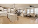 Open-concept kitchen, dining, and living area with hardwood floors and ample natural light at 2548 Ruffian Dr, Westfield, IN 46074