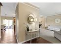 Elegant foyer with hardwood floors, a decorative table, and a glimpse into the living spaces at 300 Wyndotte Dr, Carmel, IN 46032
