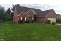Lovely single-story brick home with a lush green lawn and mature trees at 3237 Boxwood Dr, Indianapolis, IN 46227
