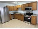 Well-equipped kitchen featuring stainless steel appliances and wooden cabinets at 3841 Monica Ct, Indianapolis, IN 46226