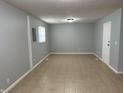 Spacious room with neutral walls, tile floor, and a white door at 3841 Monica Ct, Indianapolis, IN 46226