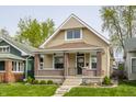 Charming bungalow-style home with a welcoming front porch, brick accents, and well-maintained lawn at 420 Orange St, Indianapolis, IN 46225