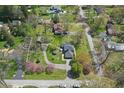 Aerial view of property showcasing lush greenery, circular driveway, and peaceful neighborhood at 4337 Lincoln Rd, Indianapolis, IN 46228