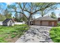Detached two-car garage with ample parking space and additional shed for storage at 4337 Lincoln Rd, Indianapolis, IN 46228