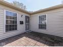 Inviting side entrance with secure door, brick patio and ample natural light at 4412 Mountbatten Ct, Indianapolis, IN 46254