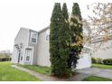 Attractive side view of a well-maintained home with manicured landscaping and a neatly paved walkway at 4545 Connaught East Dr, Plainfield, IN 46168