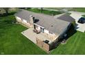 A large, private backyard with stone patio and wooden fence, perfect for outdoor entertaining at 5210 S 100 E Rd, Anderson, IN 46013