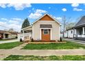 Cozy home exterior featuring manicured lawn and decorative cedar accents at 604 Wood St, Greenfield, IN 46140