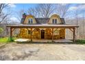 Charming stone home featuring dormer windows and a covered porch with exposed wood rafters at 6150 Red Day Rd, Martinsville, IN 46151