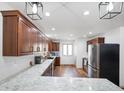 Spacious kitchen featuring ample counter space with marble countertops, stainless steel appliances, and wooden floors at 6150 Red Day Rd, Martinsville, IN 46151