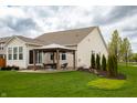 Spacious backyard features a pergola-covered patio, lush lawn, and mature landscaping at 6717 Marble Arch Way, Indianapolis, IN 46259