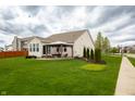 Beautiful backyard with expansive lawn, pergola-covered patio, and privacy landscaping at 6717 Marble Arch Way, Indianapolis, IN 46259