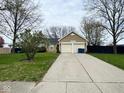 Charming single-story home with a double-car garage and a long driveway, set on a well-manicured lawn at 676 Sunblest Blvd, Fishers, IN 46038