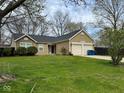 Inviting single-story home featuring a double garage, manicured lawn, and simple, clean landscaping at 676 Sunblest Blvd, Fishers, IN 46038