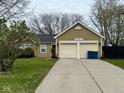 Attractive single-story home with a double garage, long driveway, and neat landscaping at 676 Sunblest Blvd, Fishers, IN 46038