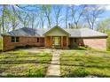 Charming brick ranch-style home with a well-maintained front yard and mature trees at 6780 E Woodland Ct, Mooresville, IN 46158