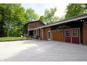 Exterior of a home with a two-car garage, well-maintained lawn, and mature trees at 701 E Main St, Westfield, IN 46074