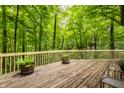 Expansive wooden deck surrounded by lush greenery, creating a serene outdoor space at 7249 Tuliptree Trl, Indianapolis, IN 46256