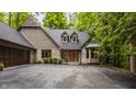 Traditional home featuring brick and wood, complemented by a spacious driveway and manicured shrubs at 7249 Tuliptree Trl, Indianapolis, IN 46256