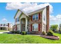 Two-story house featuring brick, shutters and a well-manicured front lawn at 7637 Sand Run Ct, Indianapolis, IN 46259