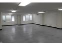Spacious basement area with multiple windows, plain walls, and fluorescent lighting at 809 S Harrison St, Alexandria, IN 46001