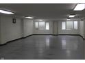 Open basement area with neutral walls, bright lighting, and door to the outside at 809 S Harrison St, Alexandria, IN 46001