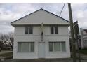Symmetrical two-story commercial building with white siding under a cloudy sky at 809 S Harrison St, Alexandria, IN 46001