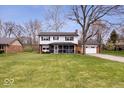 Beautifully maintained home with a lush lawn, inviting curb appeal and attached two car garage at 8180 E County Road 400 N, Brownsburg, IN 46112