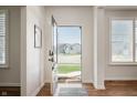 Bright foyer with an open door, showcasing a view of the neighborhood, and hardwood floors with natural light at 8452 Ironhill Ct, Indianapolis, IN 46259