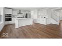Modern kitchen with white cabinets, stainless steel appliances, and a large center island at 10524 Broadford St, Indianapolis, IN 46239