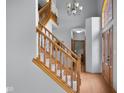 Bright foyer with hardwood floors, staircase with wooden banister, and decorative chandelier at 1121 Retford Ct, Greenwood, IN 46143