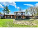 Front exterior showcasing unique architecture and a spacious front yard at 11625 Rolling Springs Dr, Carmel, IN 46033
