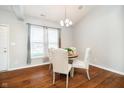 Cozy dining room featuring hardwood floors, a chandelier, and natural light from a window at 1315 Hazy Falls Blvd, Westfield, IN 46074