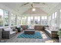 Bright sunroom with vaulted ceilings, a ceiling fan, and walls of windows overlooking backyard at 1315 Hazy Falls Blvd, Westfield, IN 46074