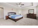 Spacious main bedroom with a comfortable bed, dresser, and soft carpet at 1334 Winfield Way, Greenwood, IN 46143