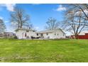 Beautiful backyard with green lawn, patio, and outdoor seating area at 1502 N Matthews Rd, Greenwood, IN 46143