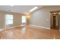 Bright living room featuring wood floors, neutral walls, recessed lighting, and large windows at 1579 Winding Creek Trl, Brownsburg, IN 46112