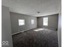 Serene bedroom with three windows and plush carpeting, offering a comfortable retreat at 1619 E 20Th St, Muncie, IN 47302
