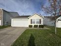 Pleasant home exterior with a manicured lawn and an attached garage, offering curb appeal at 1833 Southernwood Ln, Indianapolis, IN 46231