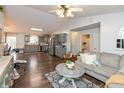 Open-concept living room showcasing hardwood floors, comfortable seating, and a seamless flow to the kitchen at 204 S Hougland St, Trafalgar, IN 46181