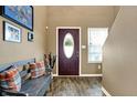 Welcoming entryway with warm tones, a stylish bench, and a decorative front door at 209 Allen Ln, New Whiteland, IN 46184
