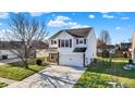 Well-maintained two-story home with lush greenery and a spacious driveway at 209 Allen Ln, New Whiteland, IN 46184