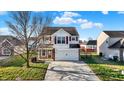 Inviting two-story home with a well-kept lawn and a convenient two-car garage at 209 Allen Ln, New Whiteland, IN 46184