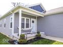 Inviting front porch with a comfortable hammock, decorative plants, and charming details at 2239 E Werges Ave, Indianapolis, IN 46237