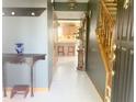 Warm foyer with wood accents, tile floors, and a view into the kitchen, offering a welcoming transition at 2303 Cole Wood Ct, Indianapolis, IN 46239