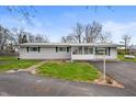 Charming single-story home with a well-maintained yard and enclosed front porch at 3335 W 400 N, Anderson, IN 46011